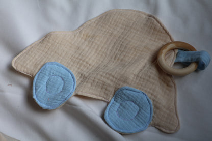 Baby teething ring with blue fabric and wooden ring on a white background